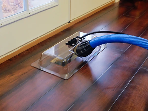 a vacuum cleaner on a wood floor