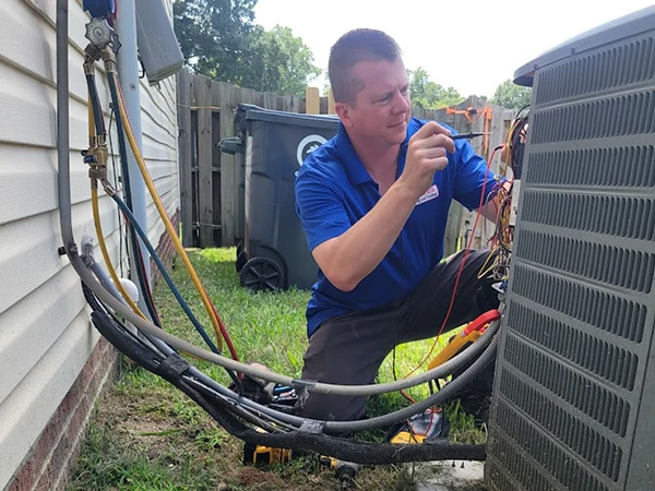 A technician repairing an AC unit